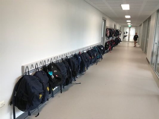 Classroom backpack hooks in school corridor